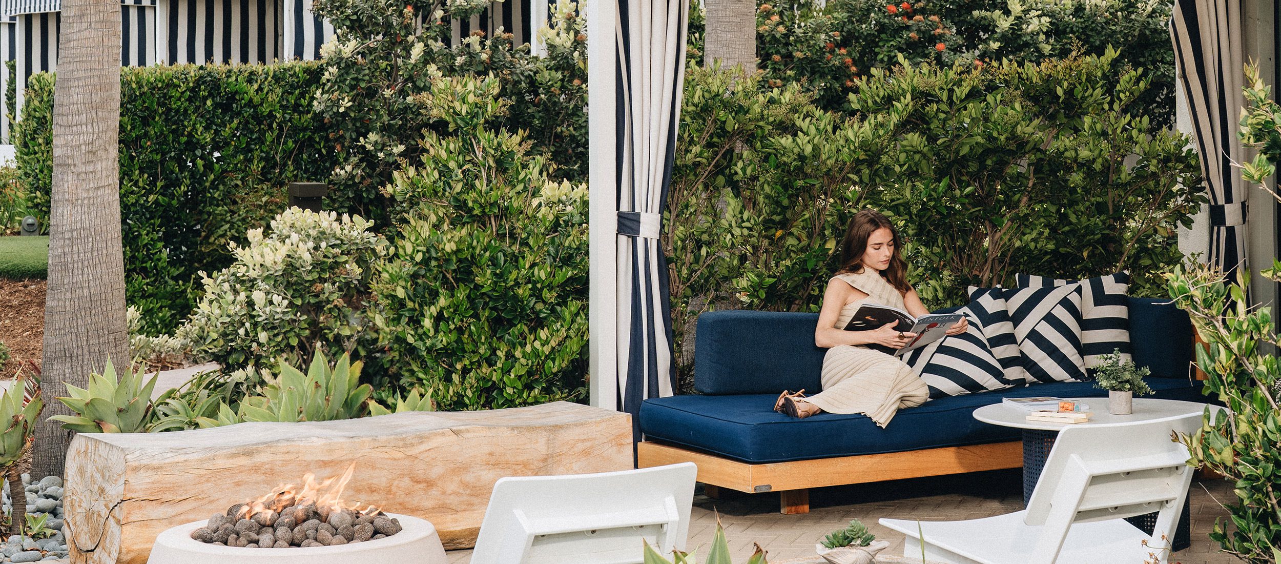 Woman reading magazine on patio