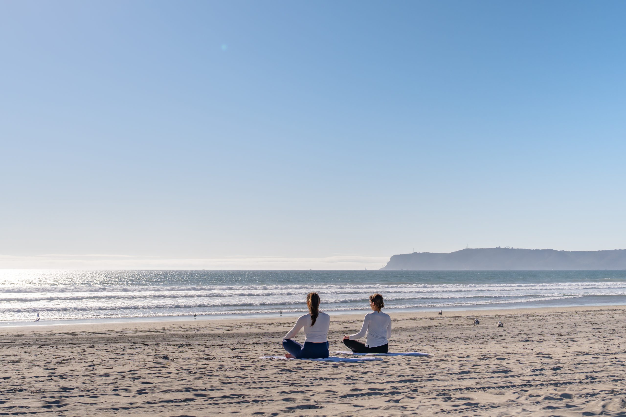 Ladies meditating on Coronado Beach