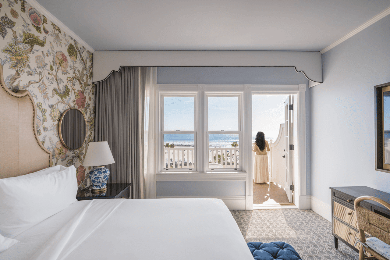 Victorian oceanfront guest room with woman on balcony